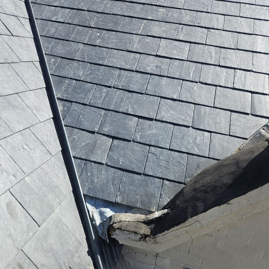 New slate roof being laid on a pitched roof in Surrey