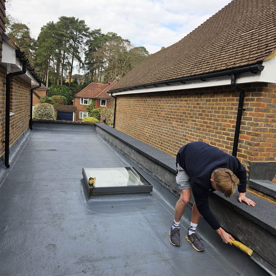 Freshly laid slate roof against clear blue sky